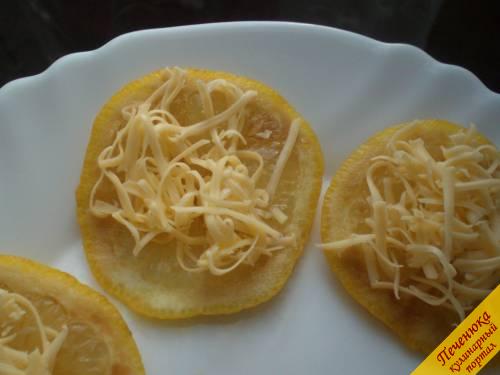 4) Достать лимоны из морозилки и на каждый пласт (он же будет выступать как порция) щедро выложить тертый сыр.