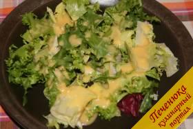 9) Начнем формировать наш салат Цезарь! На тарелку выложим листья салата. Польем их половиной соуса.